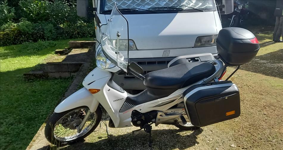 A step through Honda wave with hard luggage and a big screen