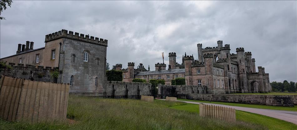 A large sprawling mix of stone buildings with crenelations that make it look a bit like a castle
