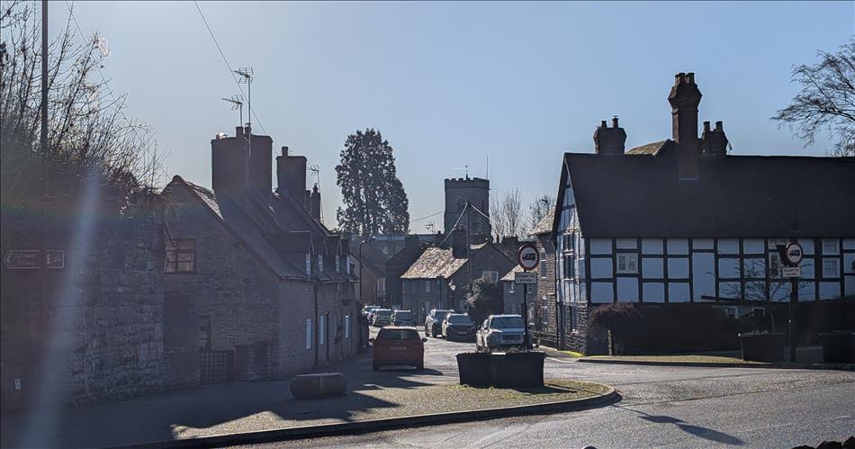 Timber framed building, pleasant street and junction, clear skies in Much Wenlock