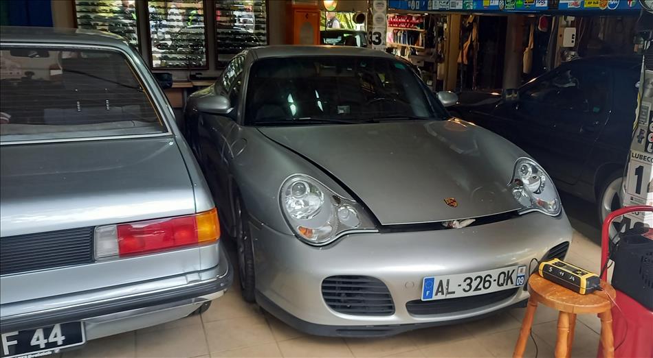 Porsche Boxter tucked into the corner of a garage