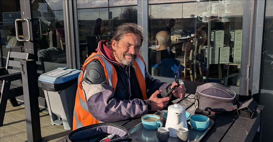 Ren squints as the sun shines in his eyes outside a cafe near to Skegness