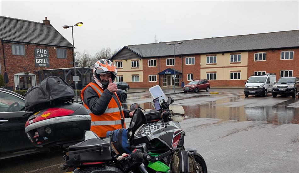 Win rain and damp wearing all his bike kit Ren gives a big thumbs up