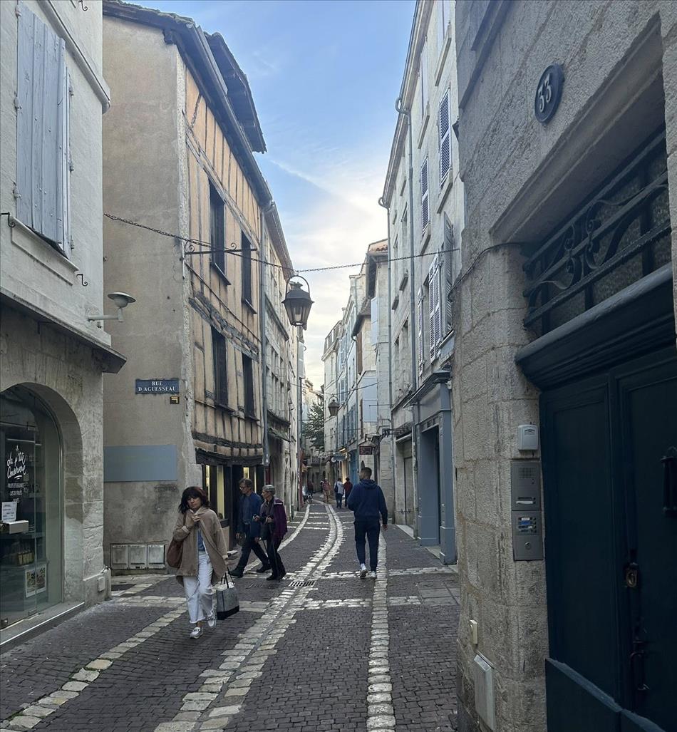 Another cobbled street, not so narrow and with shops and pedestrians