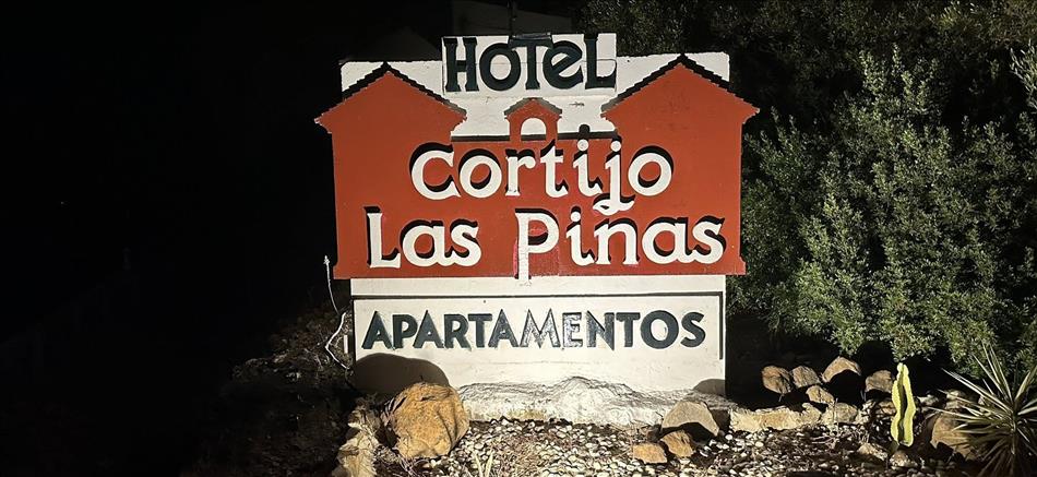 A signs reads Hotel Cortijo Las Pinas Apartamentos