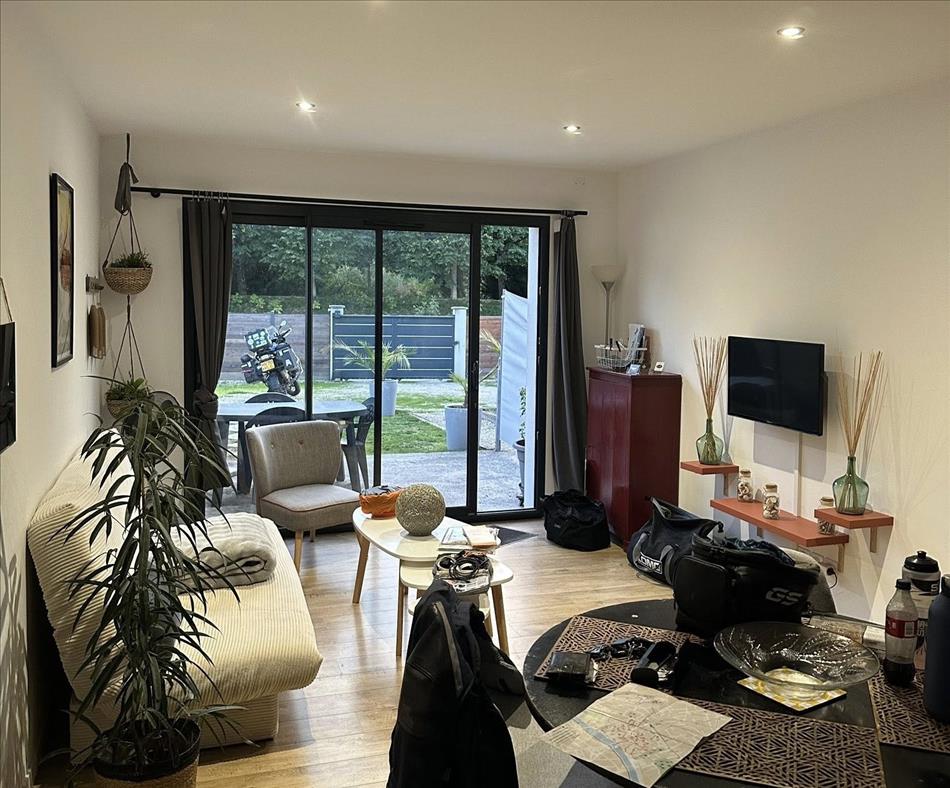 A smart room with patio doors, we can see Andy's bike in outside