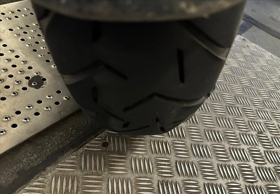 Andy's motorcycle tyre end on, we can see it is slightly squared off