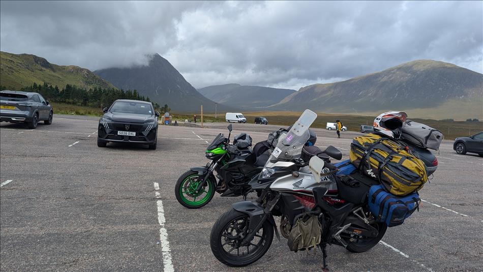 The bikes and their luggage against dramatic Highland mountains set in the mist