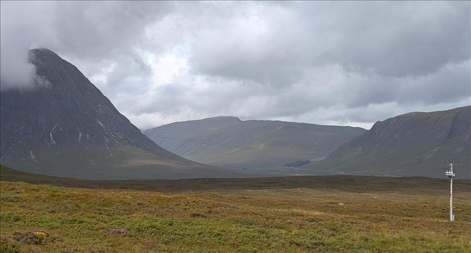 Towering Glencoe in the mist and vast empty widswept valley