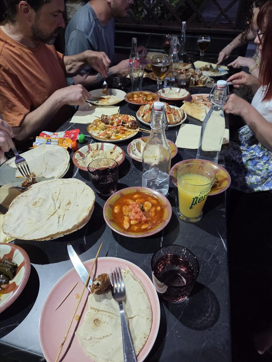 A table filled with lebanese food as the guests dine