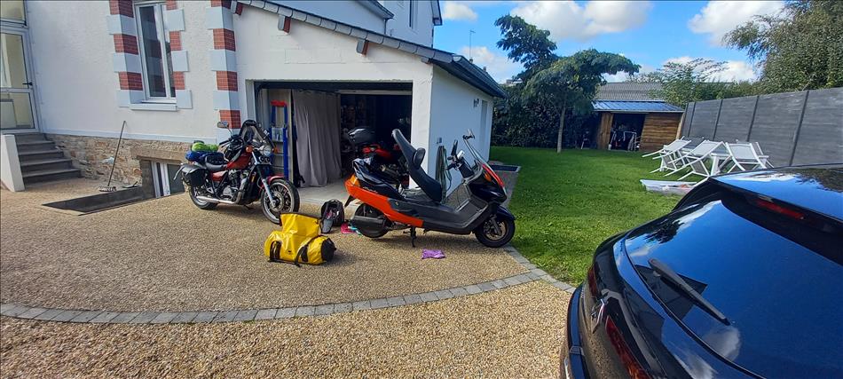 The scooter and shadow being loaded with luggage outside Ronan's smart house
