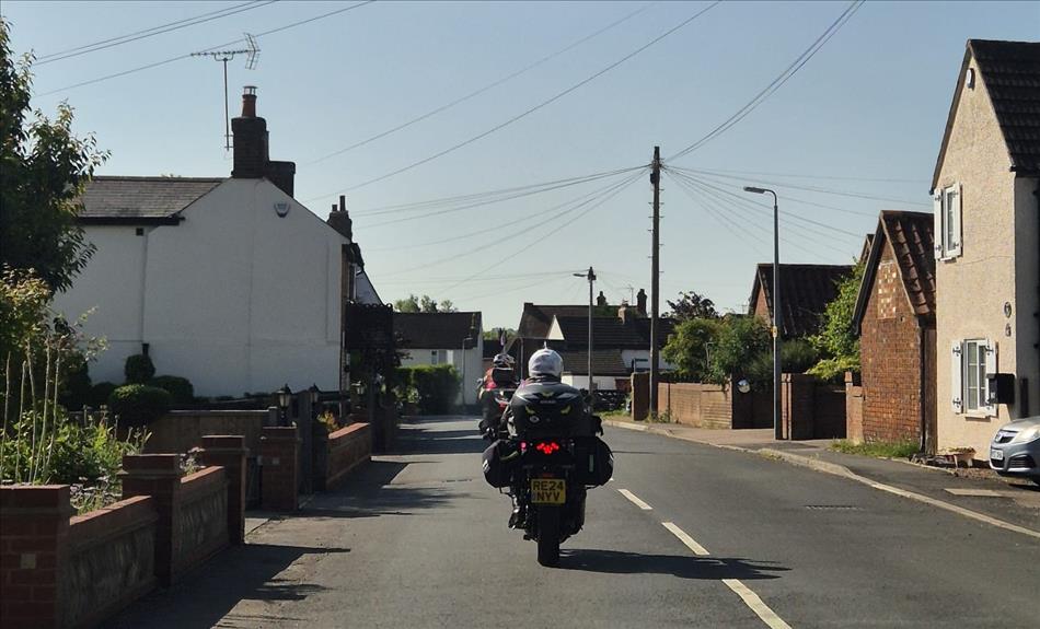 2 motorcycles and riders, Sharon and Ren, with luggage and seen from behind