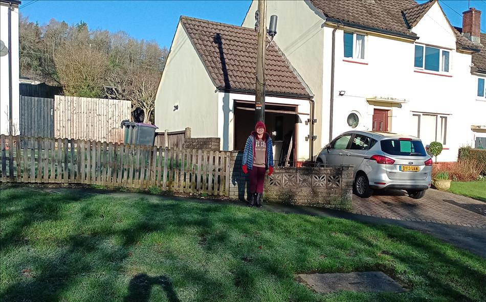 Sharon wrapped up for the cold although behind the house the sky is clear blue