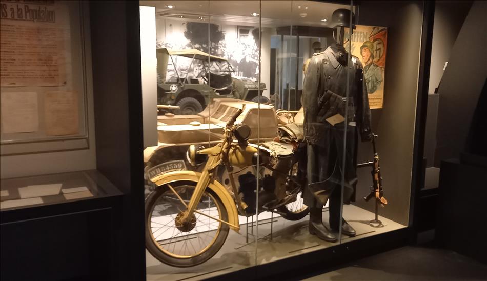 A world war 2 motorcycle and uniform in the museum
