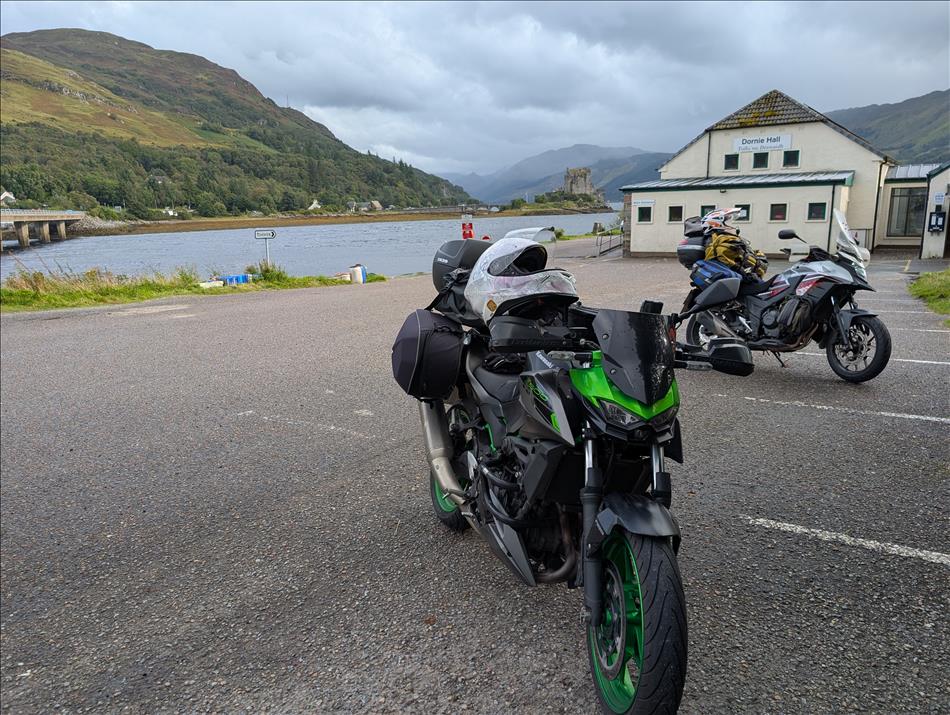 The bikes and behind is The Eilean Donan Castle and Highland scenery