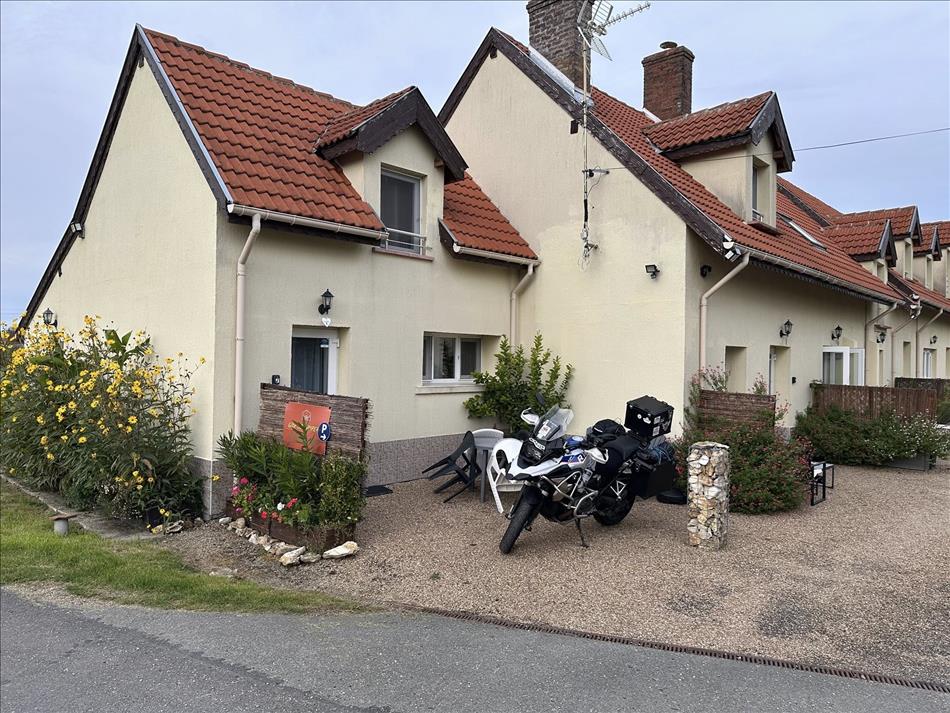 A clean cream painted rendered unit beside a large similar house in France