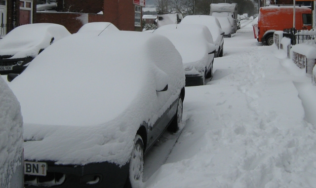 snow covers the street and cars in 2013