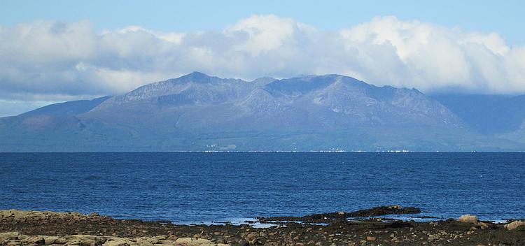 The Isle of Arran rises up from the sea as seen from the mainland
