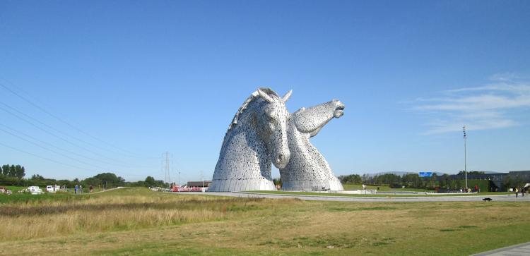 The Kelpies, 2 massive steel horse heads set against a clear blue sky