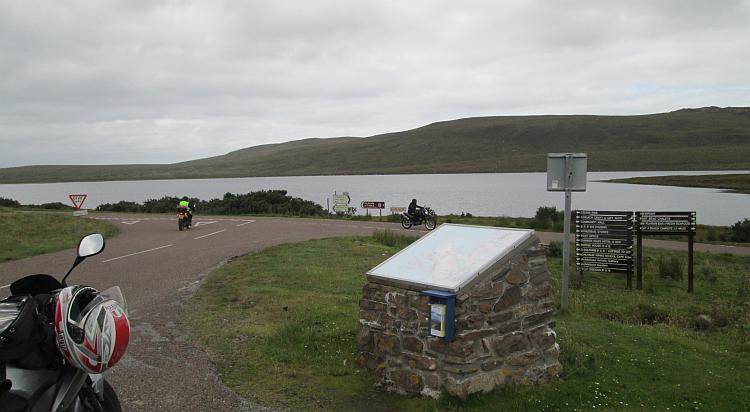 A remote junction with a plaque for tourists, idyllic scottish highland scenery