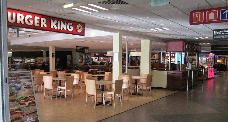 a typical motorway services with concessions, tables, chairs and shiny floors