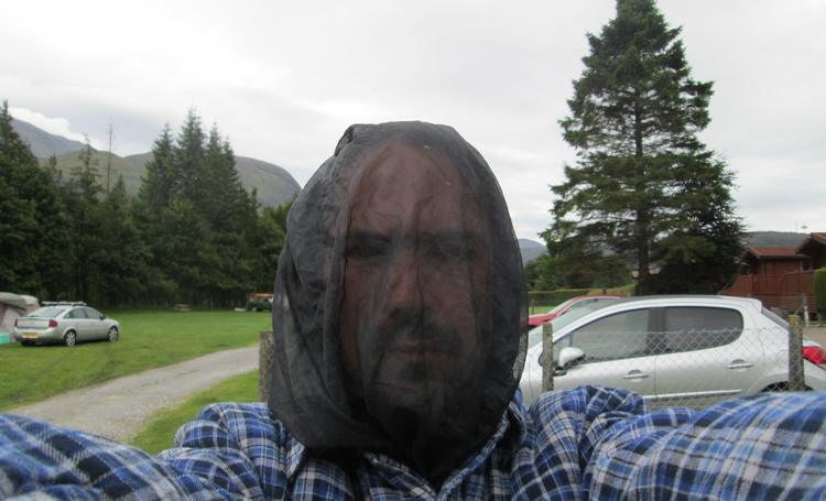 Ren has a black fine net over his head to protect him from the biting midges in Scotland