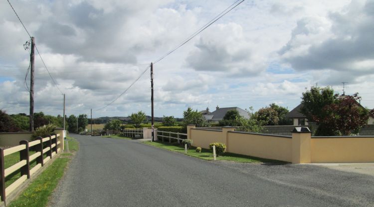 A quiet lane in Ireland with smart houses to the side