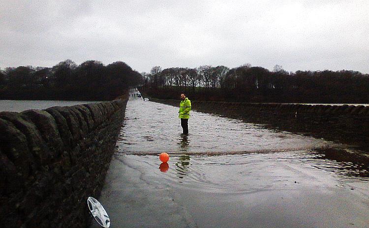 A long lane between two reservoirs, flooded and Ren stands in the flood