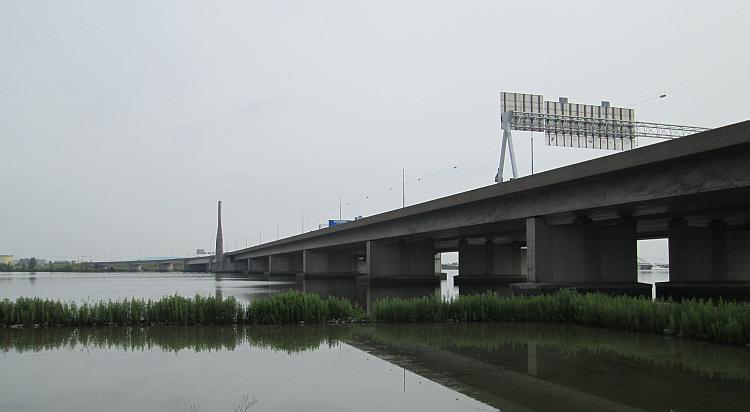 A typical concrete motorway bridge running across the lagoon