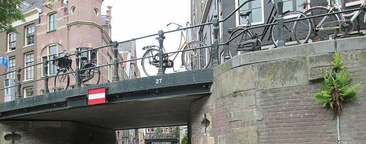 Bicycles left chained to bridge railings 