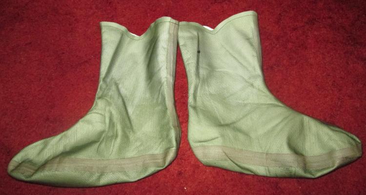 A pair of green goretex boot liners, they look like big baby's bootees