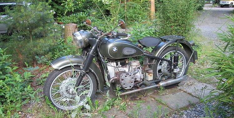 A perhaps 1950's BMW motorcycle rusting amongst the bushes at Distelloo