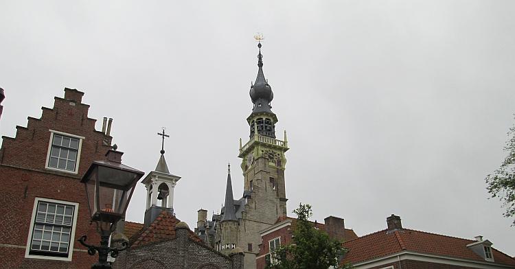 A high tower with minarets, spires and many bells at Veere town hall