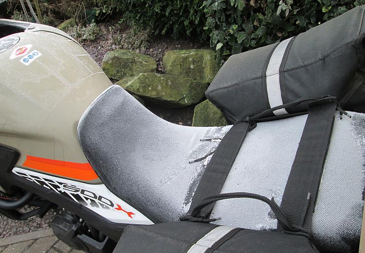A thick layer of hard frost upon Ren's motorcycle seat