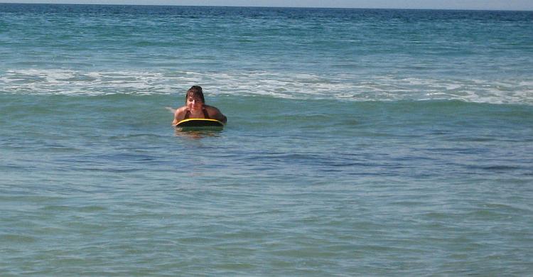 Sharon on her body board in the sun on Perranporth beach