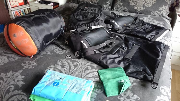 Bags, sleeping bags, clothes and kit spread out over Sharon's bed