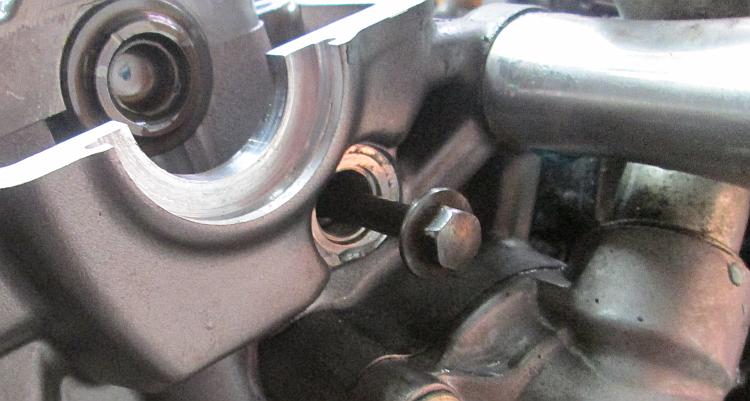 A standard M6 bolt inserted into the follower pin to remove it