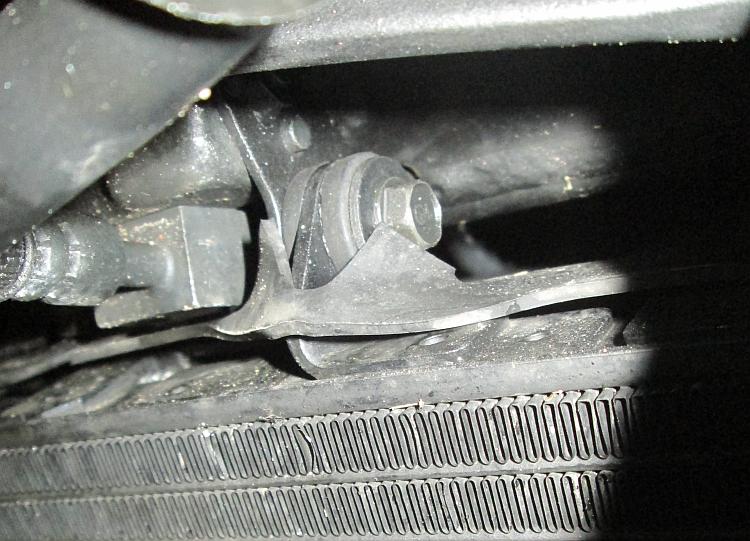 The radiator bolt that needs to be removed to get the rubber sheet out