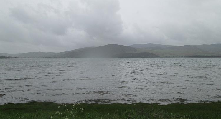 A very wet and misty view across a loch and into some hills